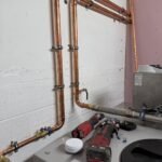 New copper pipework with isolation valves and a strainer connecting to the cold water booster set at Free Trade Wharf