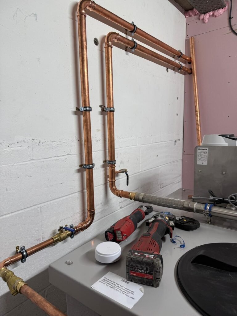New copper pipework with isolation valves and a strainer connecting to the cold water booster set at Free Trade Wharf