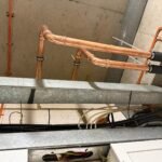 New copper pipework at ceiling level joining insulated pipe runs at Free Trade Wharf
