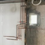 Copper pipework with isolation valves fitted to the wall at Kestral House School