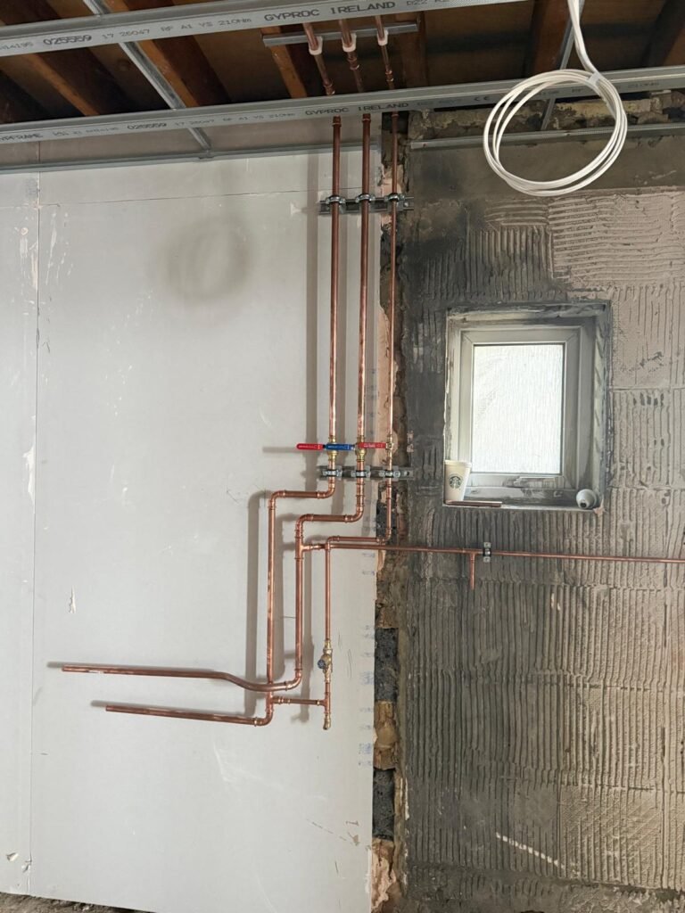 Copper pipework with isolation valves fitted to the wall at Kestral House School