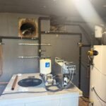 Plant room at Kestral House School with the new cold water booster pump set and water heater
