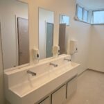 Finished school washroom at Kestral House School with a wash trough, taps and mirrors