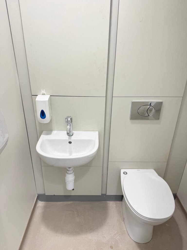 Finished WC and hand basin with concealed cistern panelling at Kestral House School