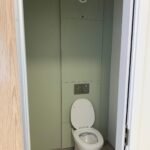 Finished WC cubicle with concealed cistern and flush plate at Kestral House School