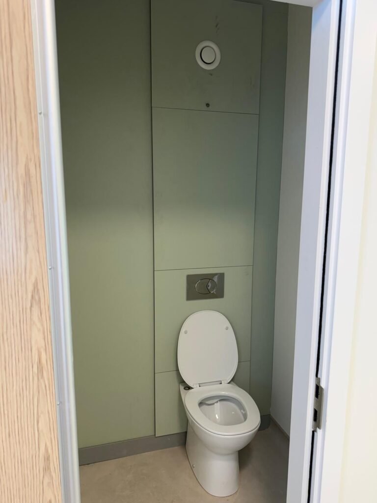 Finished WC cubicle with concealed cistern and flush plate at Kestral House School